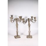 Pair of silver plated four branch, five light candelabra with scroll arms and relief foliate