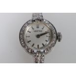 Ladies 9ct white gold Vertex wristwatch, the bezel set with small diamonds, 15 jewel Vertex Revue