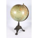 W and A K Johnston of Edinburgh New Century 12 inch terrestrial globe raised on cast iron tripod
