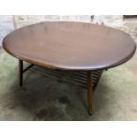 Ercol dark elm top oval coffee table with turned supports united by spindle lower tier, 44cm high