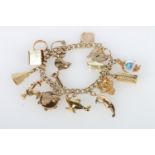 9ct gold curb link charm bracelet with fifteen yellow metal charms including Leaning Tower of