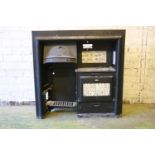 A Victorian cast iron stove with Bayeux tapestry style tiles above oven with alphabet decorated