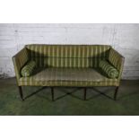 Georgian period mahogany framed three seater sofa upholstered in green silk fabric, raised on reeded