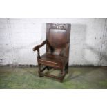 Antique provincial oak wood seat armchair, the top rail with carved floral design, 107cm tall.