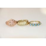 9K gold ring with 5 light blue stones, size P, and two others, 7.4g gross.