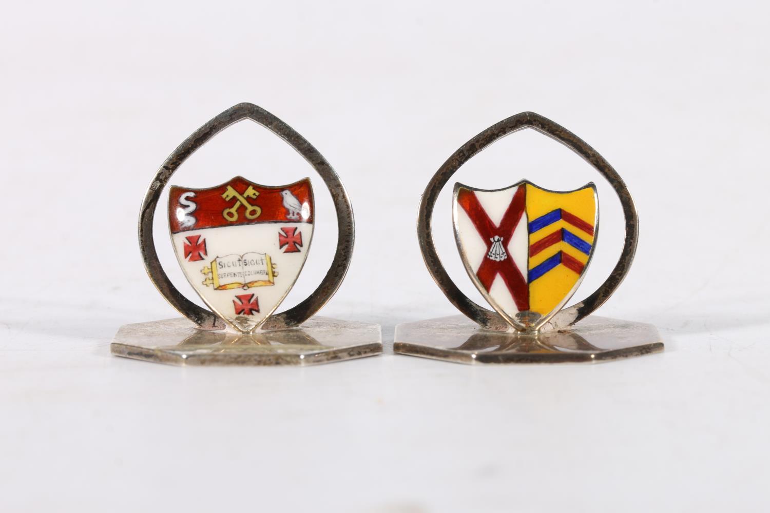 Two George V silver and enamel menu holders, one bearing the crest of Radley College by John William