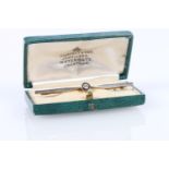 Unhallmarked yellow and white metal bar brooch set with central round diamond, 4.2g, in Godfrey