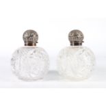 Pair of Victorian spherical cut glass scent bottles with silver covers by Hilliard & Thomason,