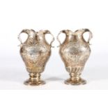 Pair of Continental silver vases in the Dutch style with repoussé farming scene vignettes and