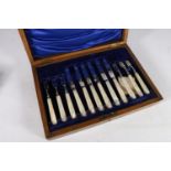 Cased set of six mother-of-pearl handled fruit knives and forks with silver blades and tines by