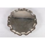 Colonial Indian Sterling silver salver with piecrust edge, raised on three squat supports with pad