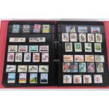 Red binder of unused British mint stamps including regionals, greetings, definitives etc., estimated