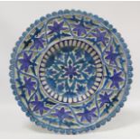 Antique Islamic Isnik or Persian circular pottery charger or rosewater dish decorated with central