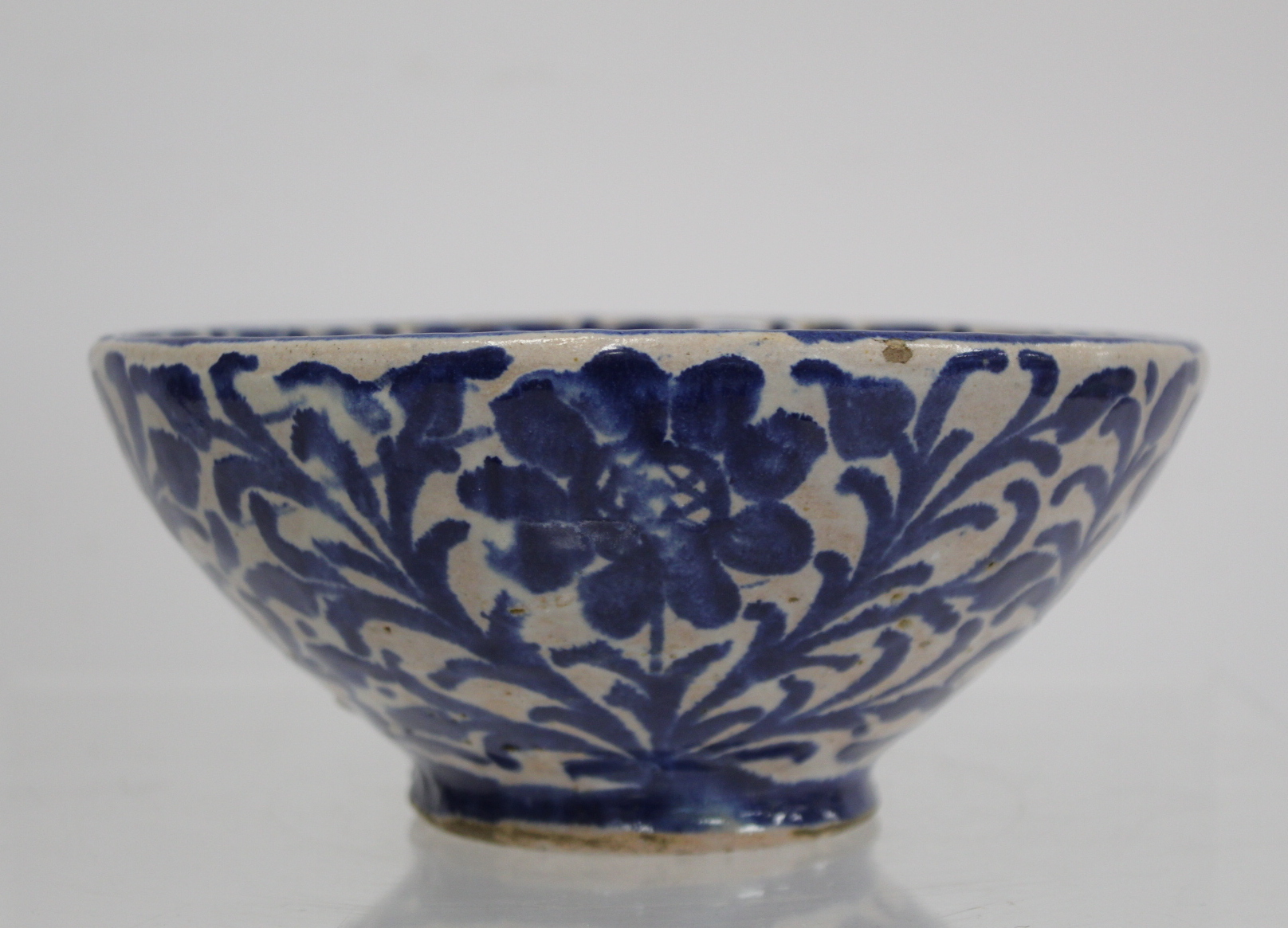 Middle Eastern small earthenware blue and white circular bowl decorated with stylised flowers and - Image 9 of 12