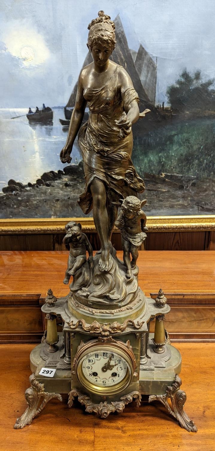 French gilt spelter and onyx figural mantle clock, the top with a standing female allegorical figure