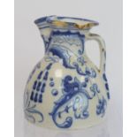 Spanish Talavera de la Reina tin glazed blue and white jug of domed form with trefoil rim, decorated