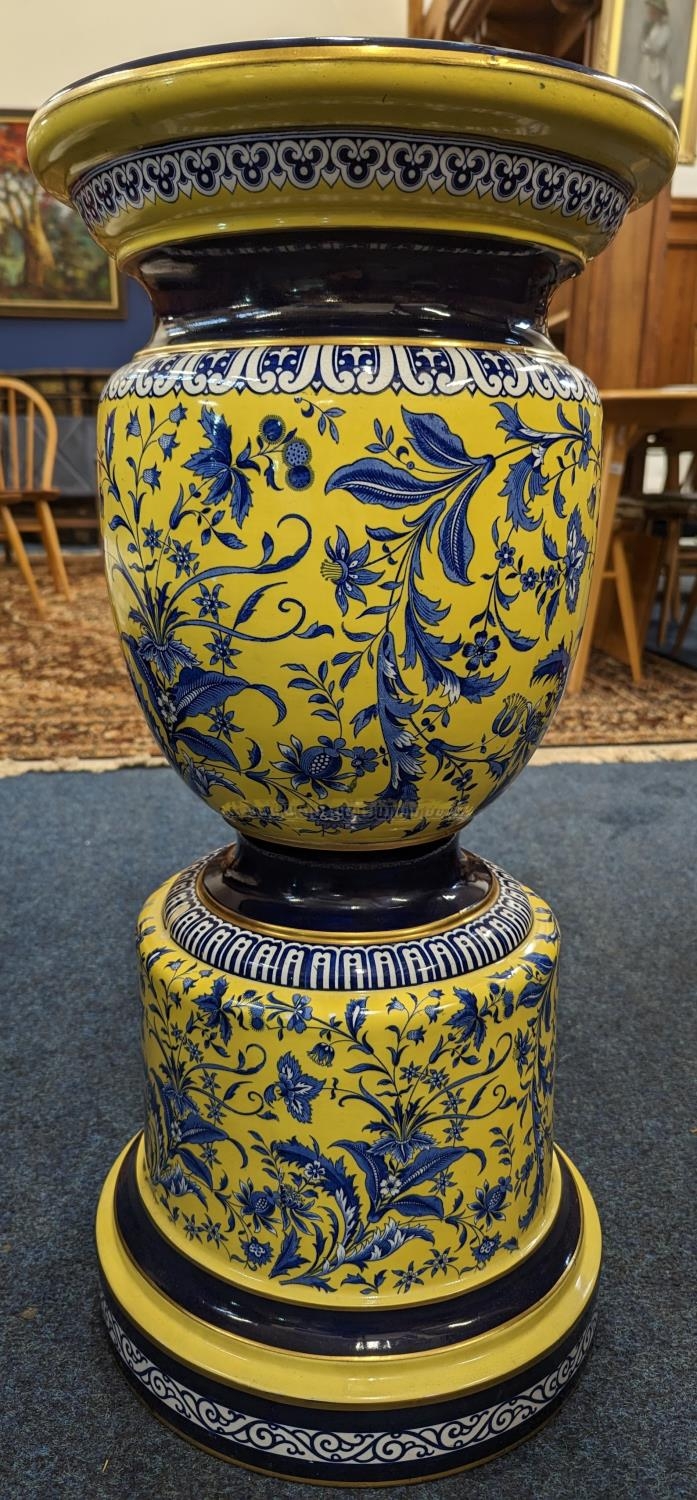 20th century pottery jardinière stand, the yellow ground decorated with blue floral spray, 71cm
