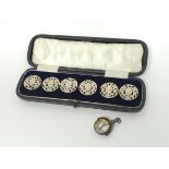 Set of six silver pierced buttons by Liberty 1900, cased, and a silver compass.