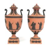 Pair of 20th Century Wedgwood Rosso Antico covered vases of urn form with twin scroll handles,