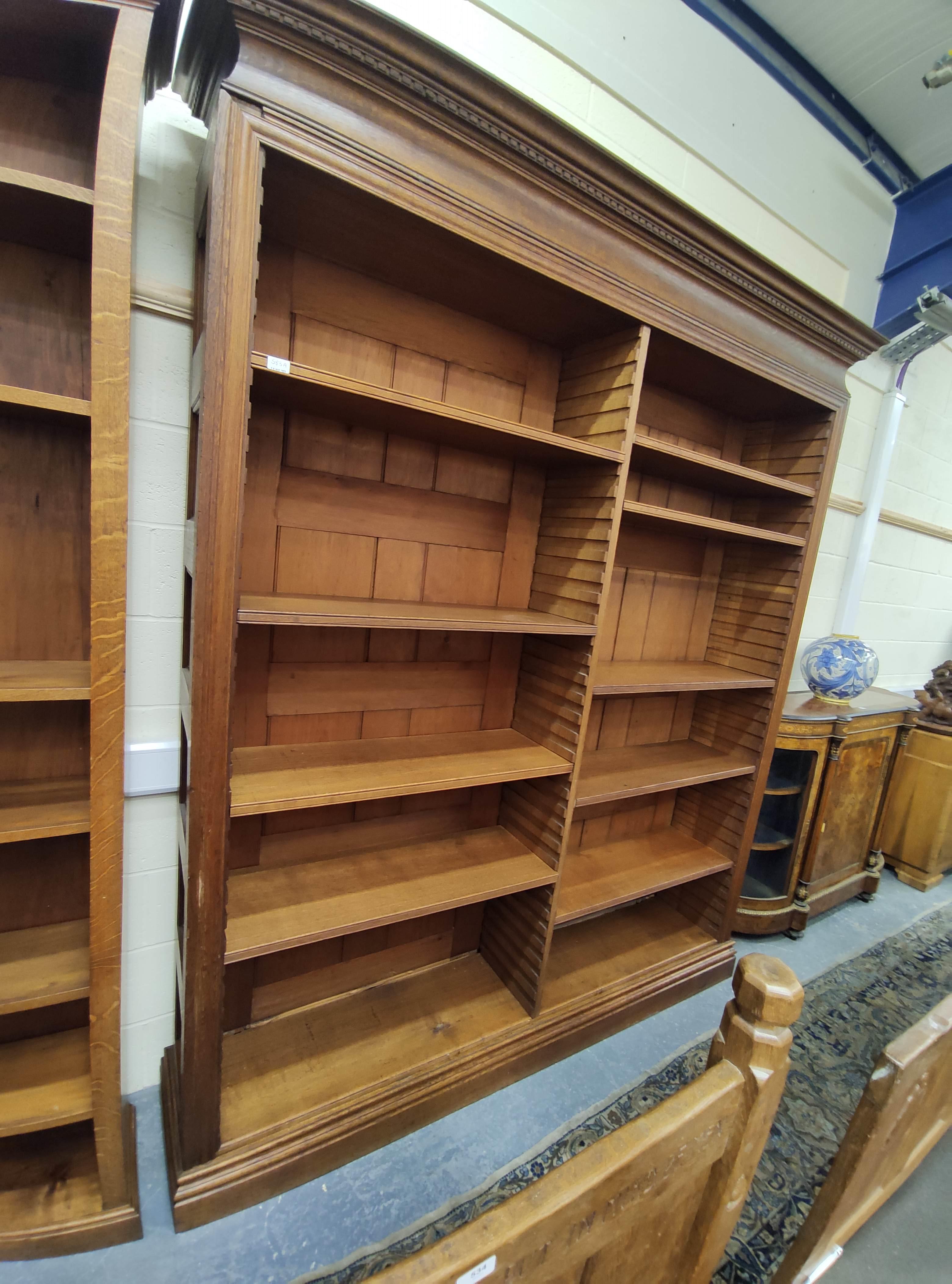 Late 19th/early 20th century large oak open front library bookcase in two sections, with pine back