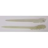Two Chinese pale celadon jade hair pins, each with pierced and carved ends, 17cm and 16cm long.  (