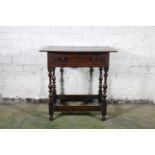 An 18th century oak side table, the top with moulded edge over frieze drawer with later handles,