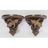 Pair of Victorian or Edwardian walnut wall brackets, the demi lune tops on tapered supports