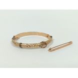 9ct gold hinged bangle and a similar pin. 22.6g.