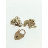 9ct gold padlock and two charms. 7g