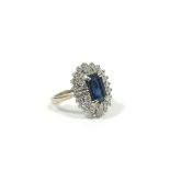 Diamond and sapphire oval cluster ring with four tapering baguettes, two rows of brilliants and