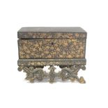 Early 19th century Chinese export black lacquer box on pierced stand with painted gilt floral and