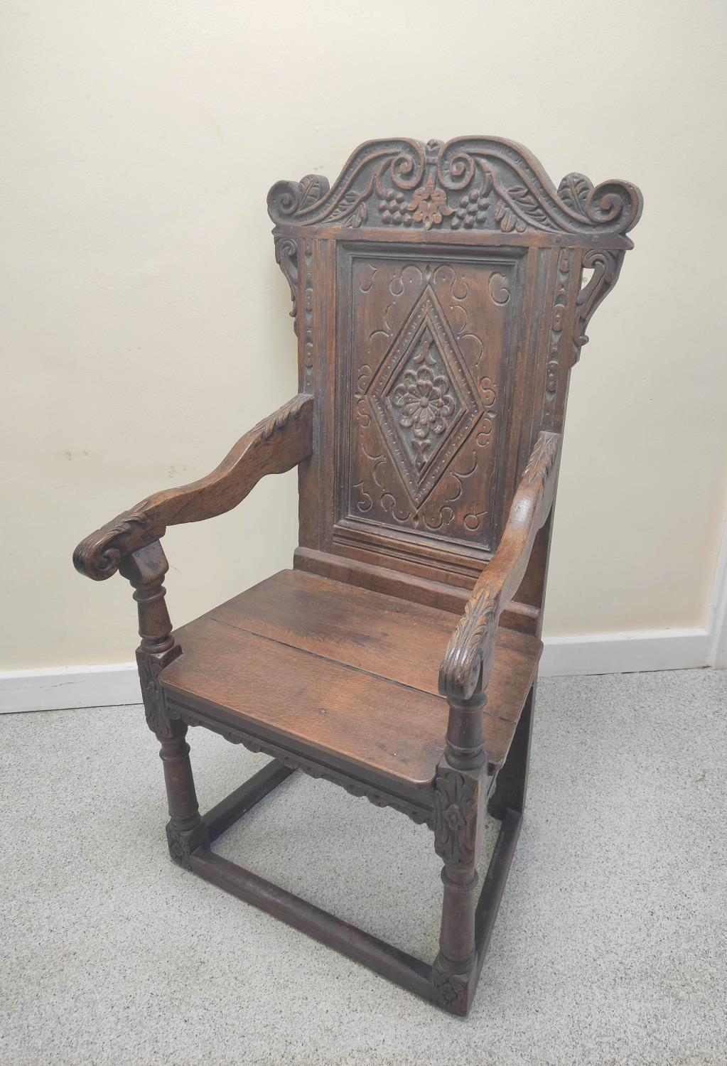 17th century and later oak wainscot armchair, North of England, the carved panelled back above