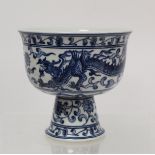 20th century Chinese blue and white stem cup decorated with a scrolling dragon amongst flowers and