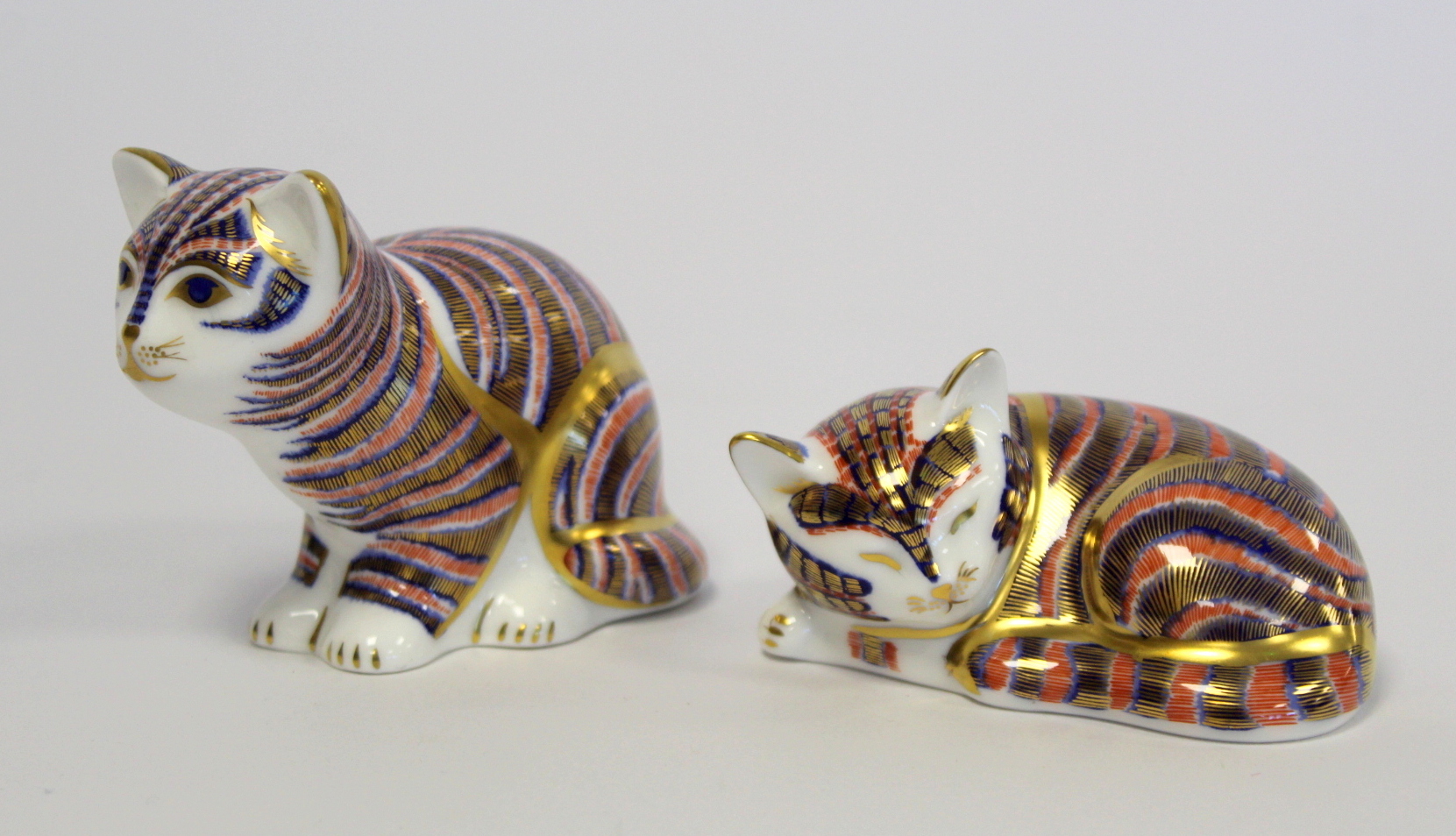 Two Royal Crown Derby Imari paperweights: "Kitten" (sitting), 6.5cm high and "P/W Sleep Kitten", 2½