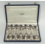 Set of twelve Swedish silver coffee spoons with crested enamel terminals, cased, 52g.