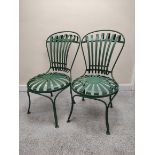 Attributed to Francois Carre, a pair of green painted wrought iron cafe chairs with sunburst