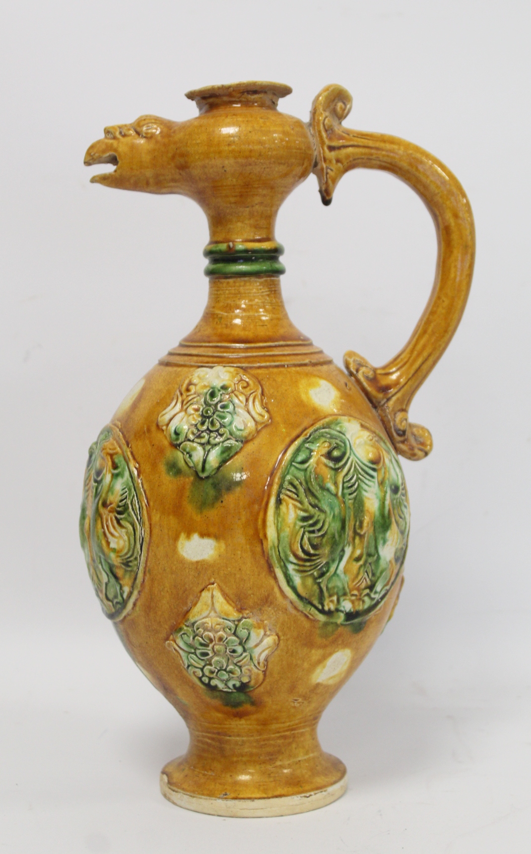 Chinese sancai glazed pottery phoenix head ewer in the Tang dynasty style, the ovoid body with