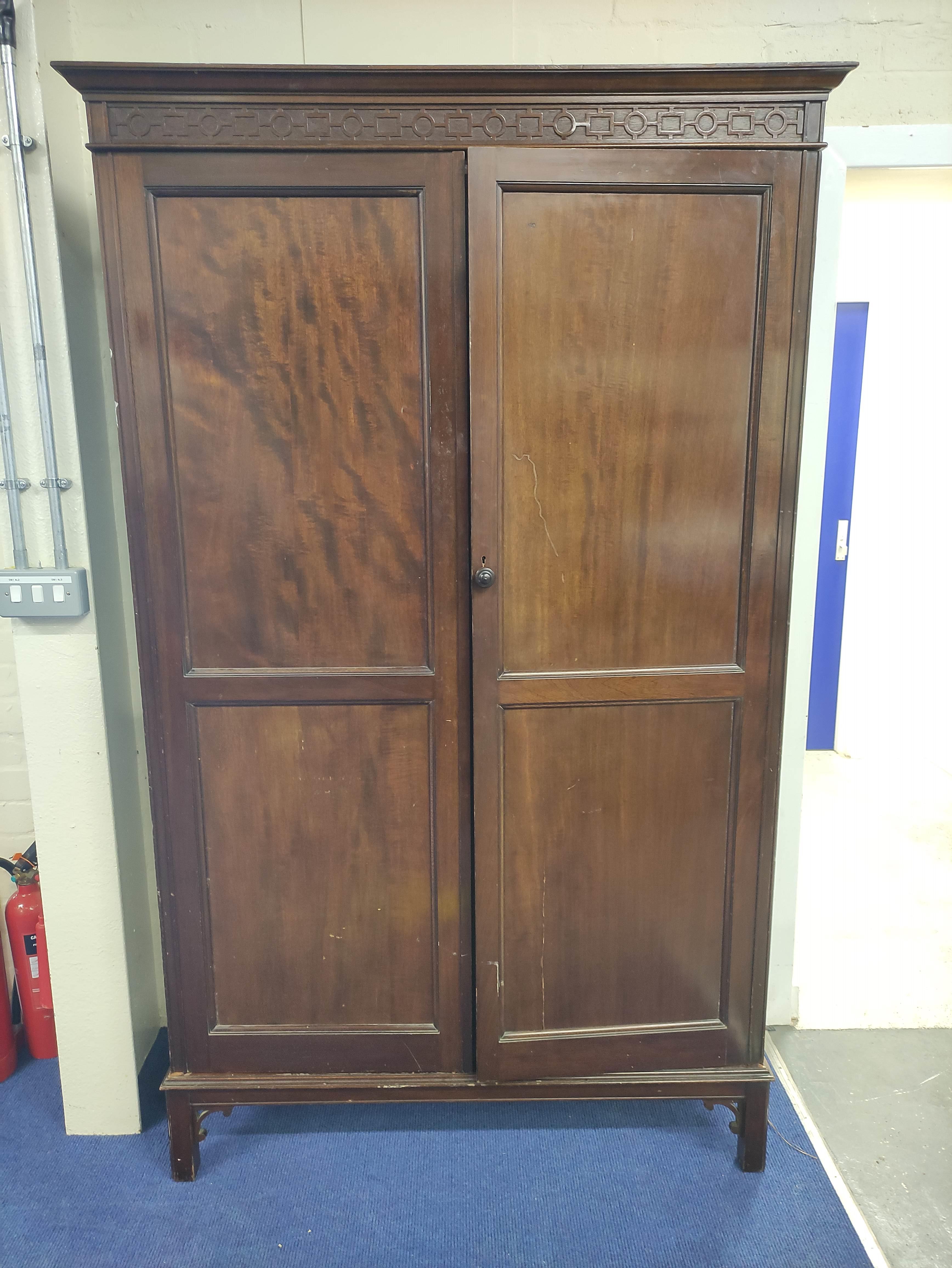 20th century mahogany wardrobe, the pair of double panel doors enclosing interior with hanging