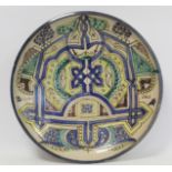 Large Islamic earthenware charger of circular form with geometric and stylised foliate decoration in