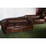 Pair of brown leather button-back three-seater Chesterfield sofas, 196cm long.