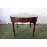 Antique mahogany drum dining table, the circular top above frieze with four drawers, raised on