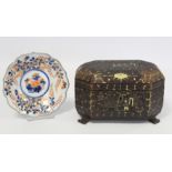 19th century Chinese black lacquer tea caddy of octagonal form with four paw feet and gilt painted