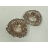 Pair of pierced and embossed bon bon dishes of heart shape, 133g.