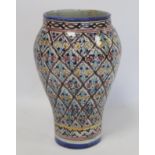 Islamic Iznik style tin glazed earthenware vase of baluster form, probably Moroccan, with polychrome