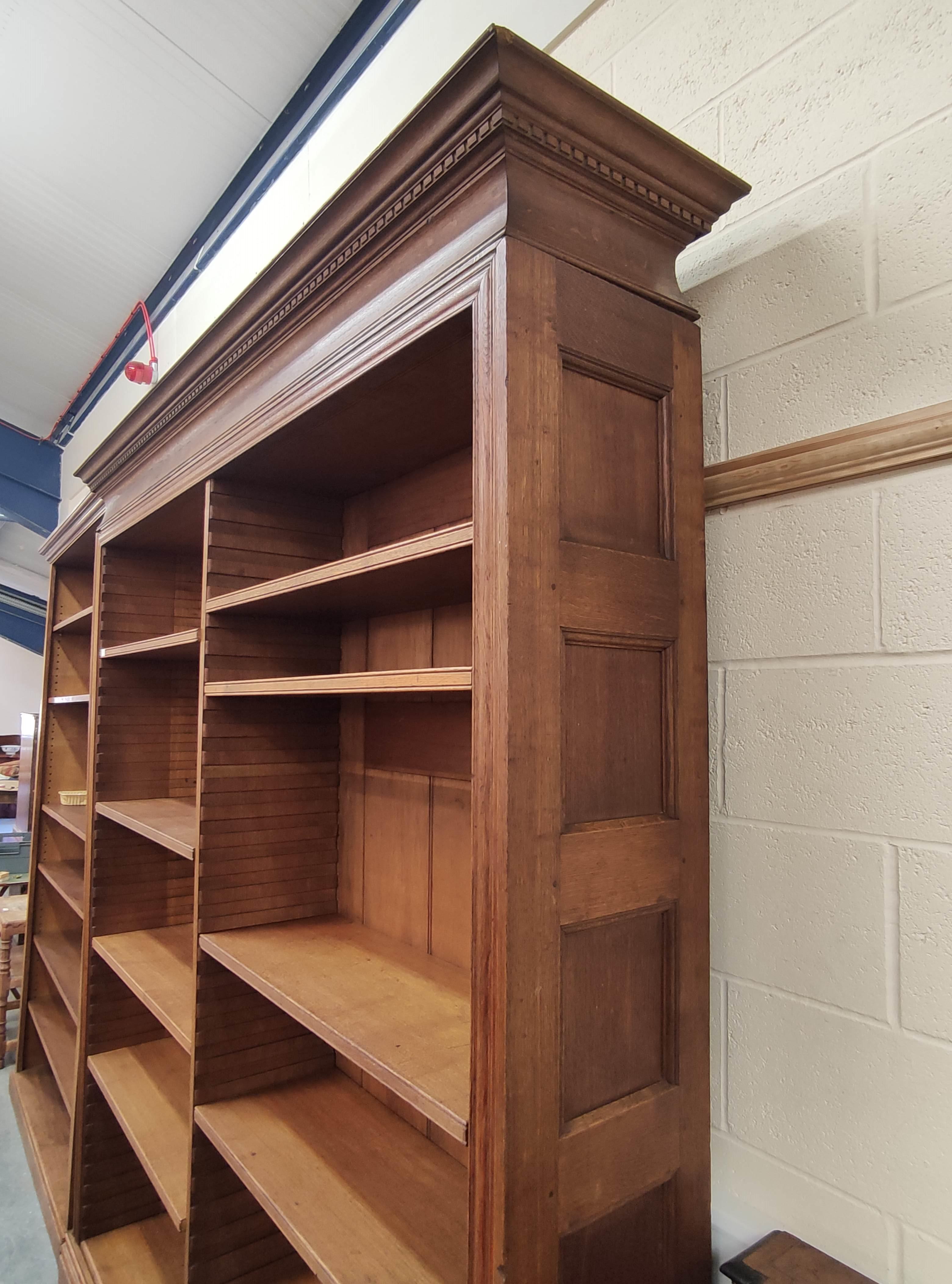 Late 19th/early 20th century large oak open front library bookcase in two sections, with pine back - Image 3 of 3