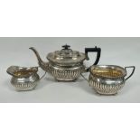 Silver three piece tea set of fluted boat shape by Sheffield 1904. 1190g./38oz approx.