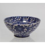 Middle Eastern small earthenware blue and white circular bowl decorated with stylised flowers and