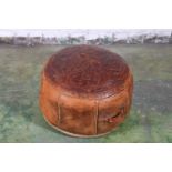Moroccan tooled leather circular pouffe, the top decorated with scrolling foliate sprays, 45cm