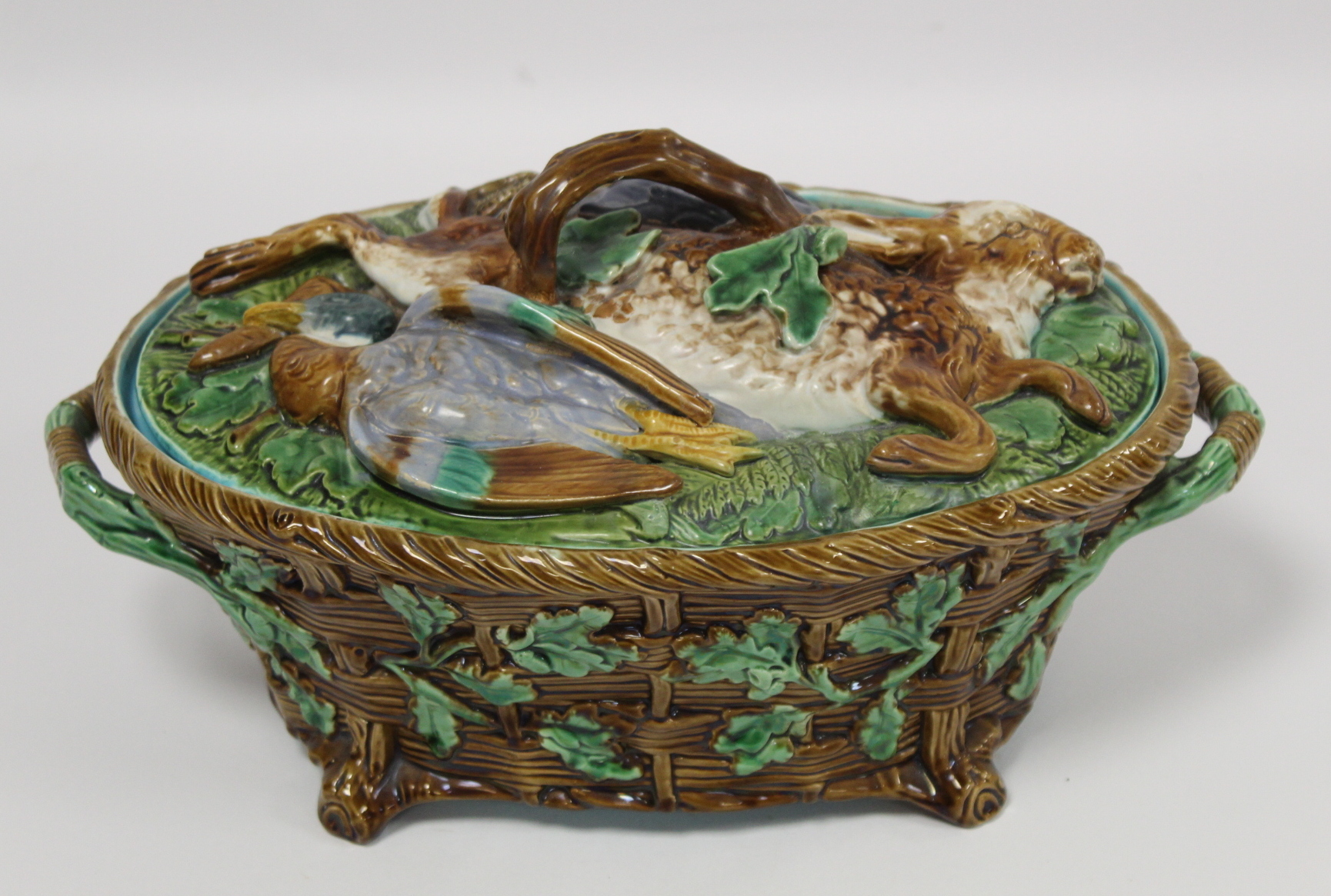 Victorian Minton majolica game pie tureen of twin handled oval form, the relief moulded naturalistic