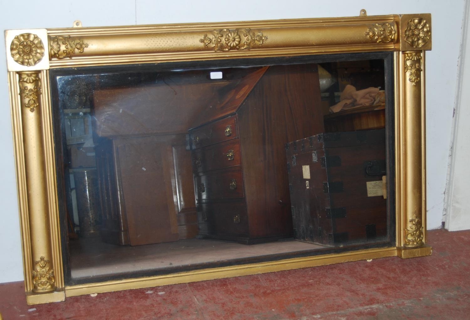 19th century Regency-style giltwood overmantel mirror decorated with moulded rose roundels, mirror